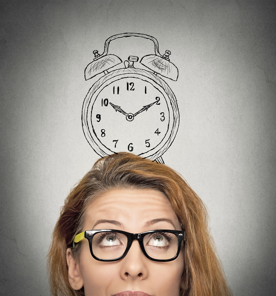 closeup headshot young business woman with alarm clock drawing sketch above her head, isolated grey wall background. Human face expressions, emotions. Time, punctuality, busy schedule concept.jpeg